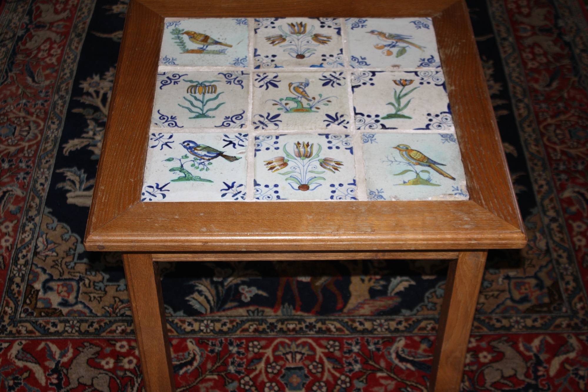 Tisch mit 9 antiken, polychromen Delfter Fliesen, 5 Vogel-,  4 Blumenmotive, 1. Hälfte 17. Jh.